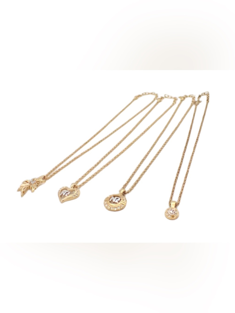 4 Nina Ricci necklaces. Gold toned